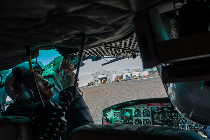 Pilot Mike Jansen does the preflight checks on a Bell 212 before taking off