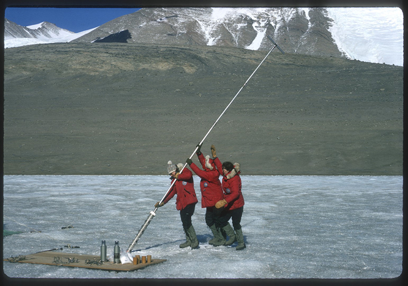(Left to Right) Terry Tickhill, Kay Lindsay and Eileen McSaveney work together to hand auger through 14 feet of ice on Lake Bonney in the Taylor Valley.