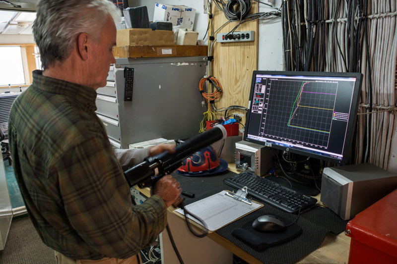 Marine Tech Chuck Holloway prepares an expendable bathythermograph