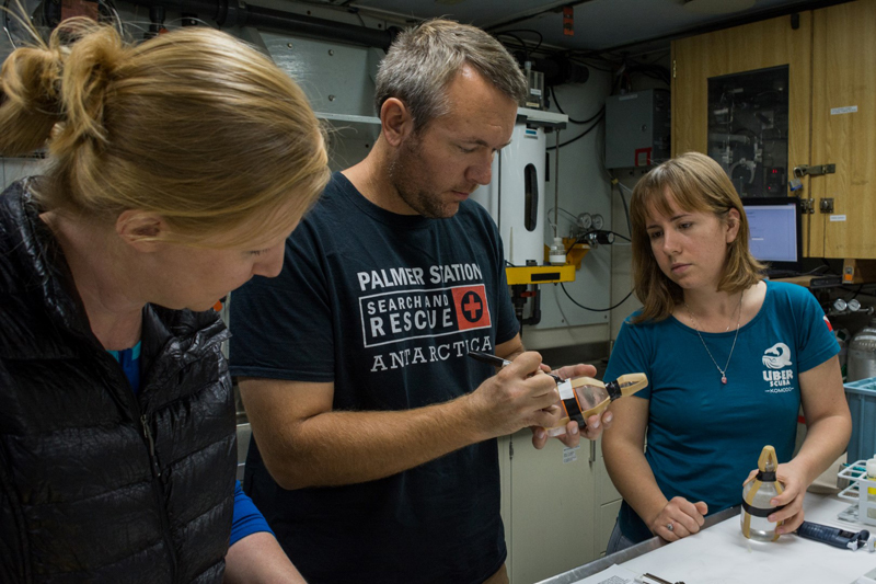 (Left to right) Marine techs Amy Belcher and Dave Moore with the help of grantee Leigh West, prepare a water sample