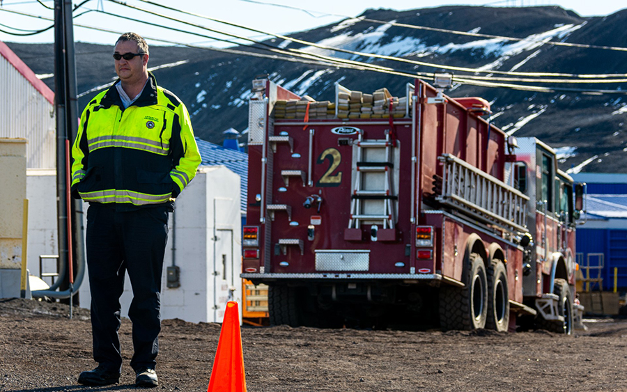 Fire Chief Neel Pahl watches a hose test in front of the fire station at McMurdo Station. 