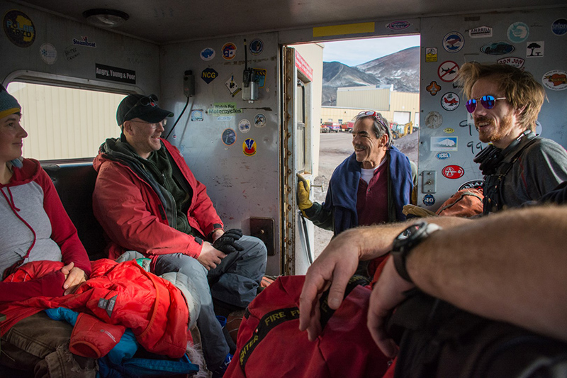 Shuttle Bob (center) checks on the riders loaded into the passenger cabin of one of the passenger Deltas before driving to the airfield.