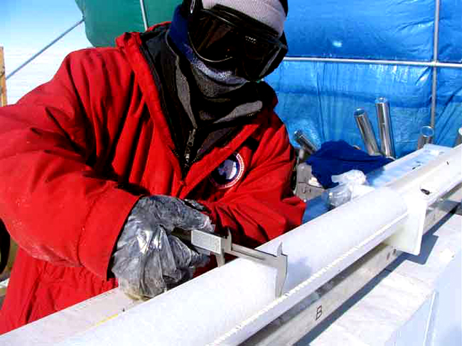 Scientist Dan Dixon measures an ice core.