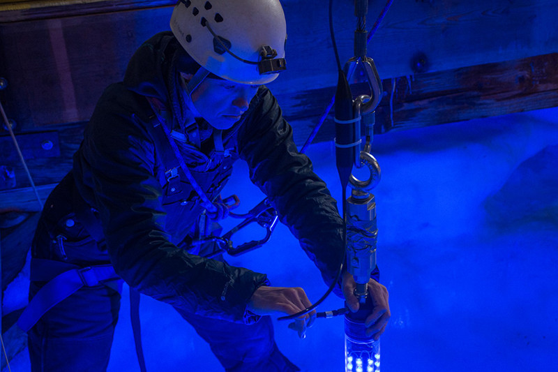 Vickie Siegel connects a wire to the light-up boom that the robot homes in on at the end of each of its missions